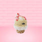 Cute kawaii bunny Peppermint Bark white ice cream with peppermint pieces and a peppermint candy on top of the bunny near the whipped cream swirl. This view is from the other side.