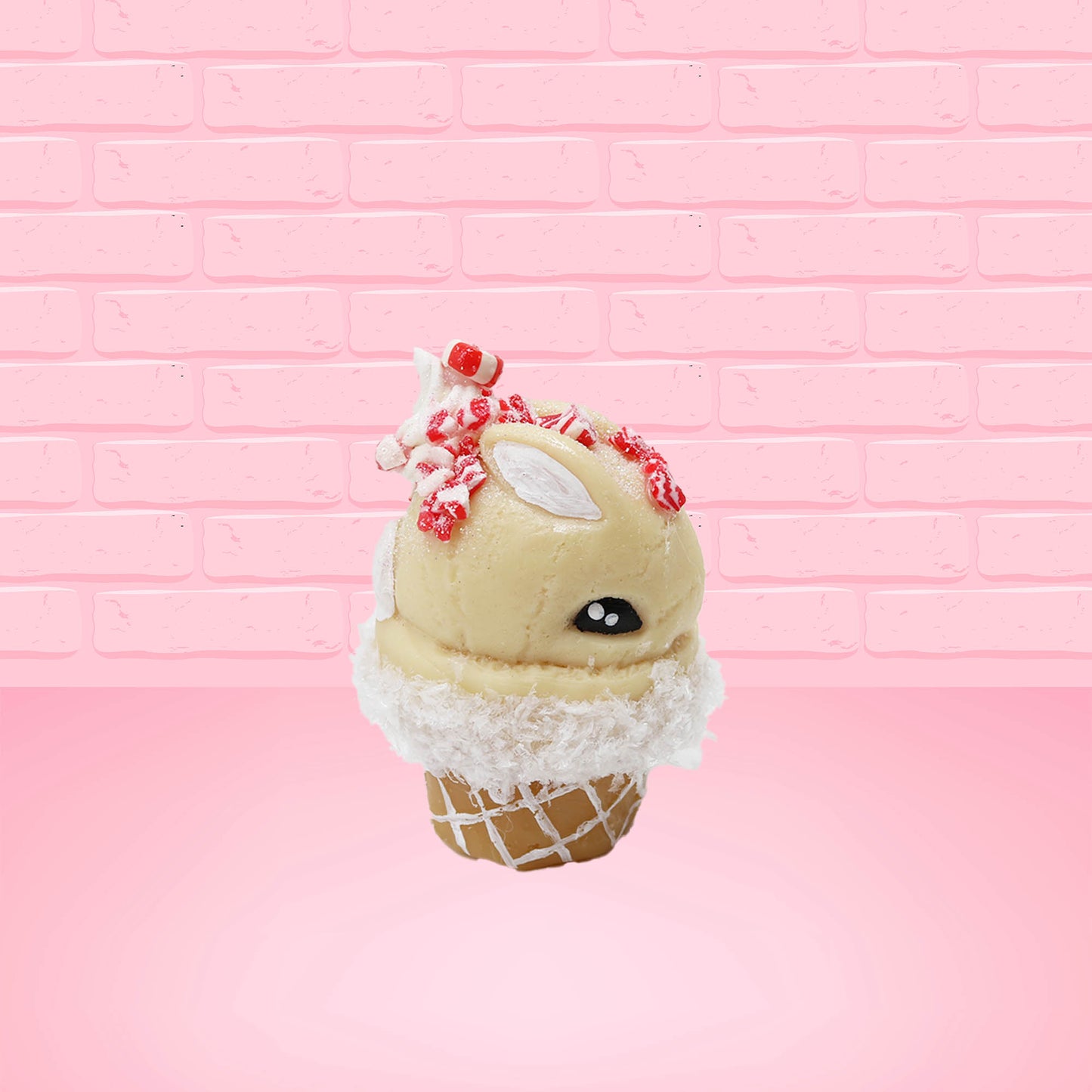 Cute kawaii bunny Peppermint Bark white ice cream with peppermint pieces and a peppermint candy on top of the bunny near the whipped cream swirl. This view is from the other side.