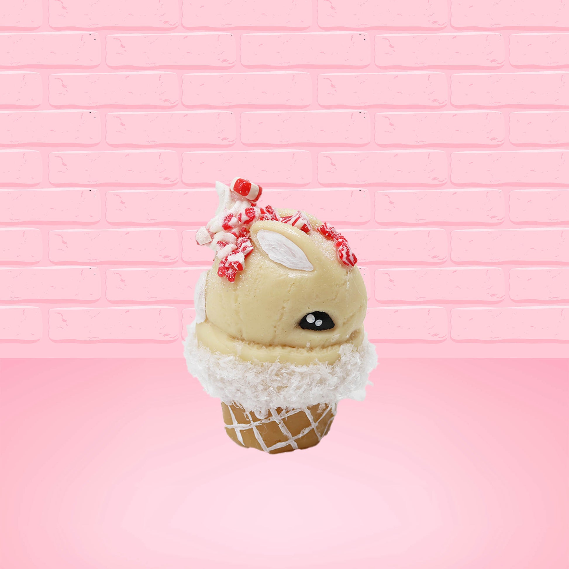 Cute kawaii bunny Peppermint Bark white ice cream with peppermint pieces and a peppermint candy on top of the bunny near the whipped cream swirl. This view is from the other side.