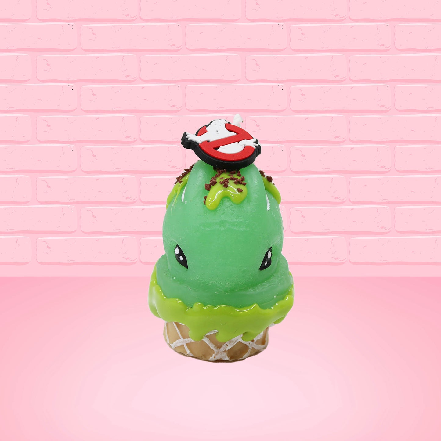 Cute kawaii bunny Slimer Scoop green ice cream cone with green drizzle and brown bits, a ghost buster logo near the whipped cream swirl on top. This view is from the front.