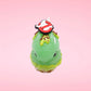 Cute kawaii bunny Slimer Scoop green ice cream cone with green drizzle and brown bits, a ghost buster logo near the whipped cream swirl on top. This view is from the top side.