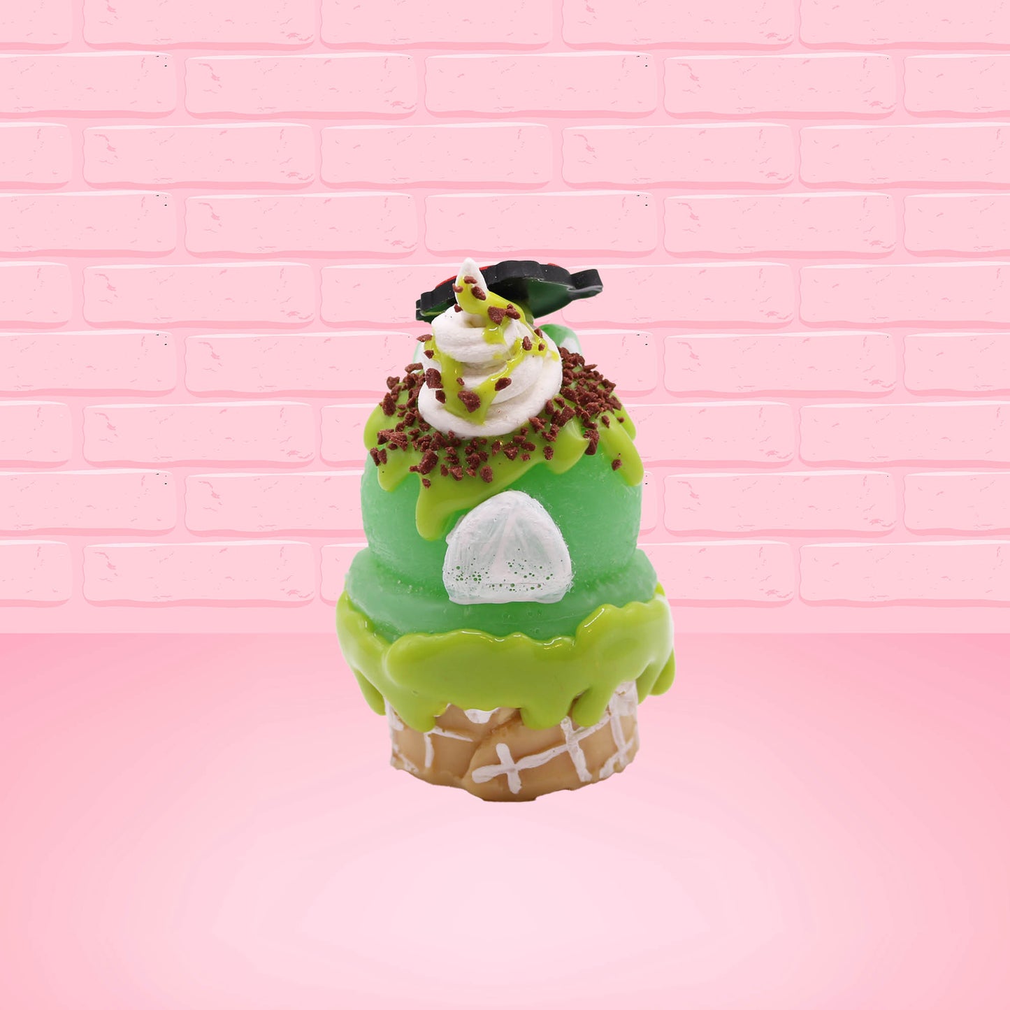 Cute kawaii bunny Slimer Scoop green ice cream cone with green drizzle and brown bits, a ghost buster logo near the whipped cream swirl on top. This view is from the back.