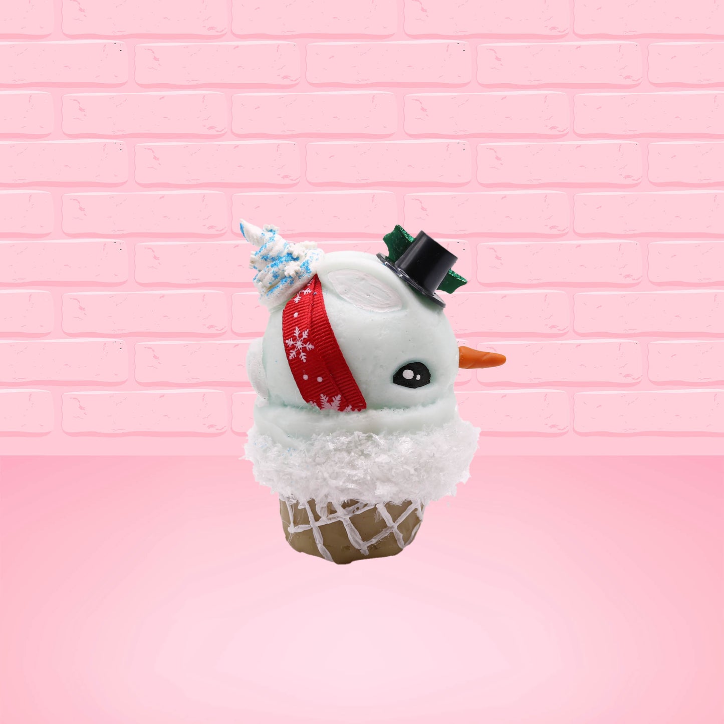 Cute kawaii bunny Snow Bunny light blue ice cream scoop with a carrot nose, red with silver snowflakes ribbon, a black top hat, and holly leaves with berries near the blue glittered whipped cream swirl on the top of the bunny. This view is from the other side.