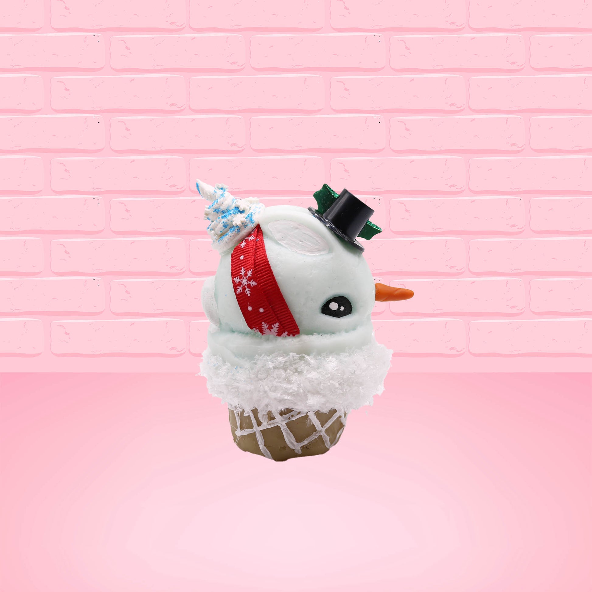 Cute kawaii bunny Snow Bunny light blue ice cream scoop with a carrot nose, red with silver snowflakes ribbon, a black top hat, and holly leaves with berries near the blue glittered whipped cream swirl on the top of the bunny. This view is from the other side.