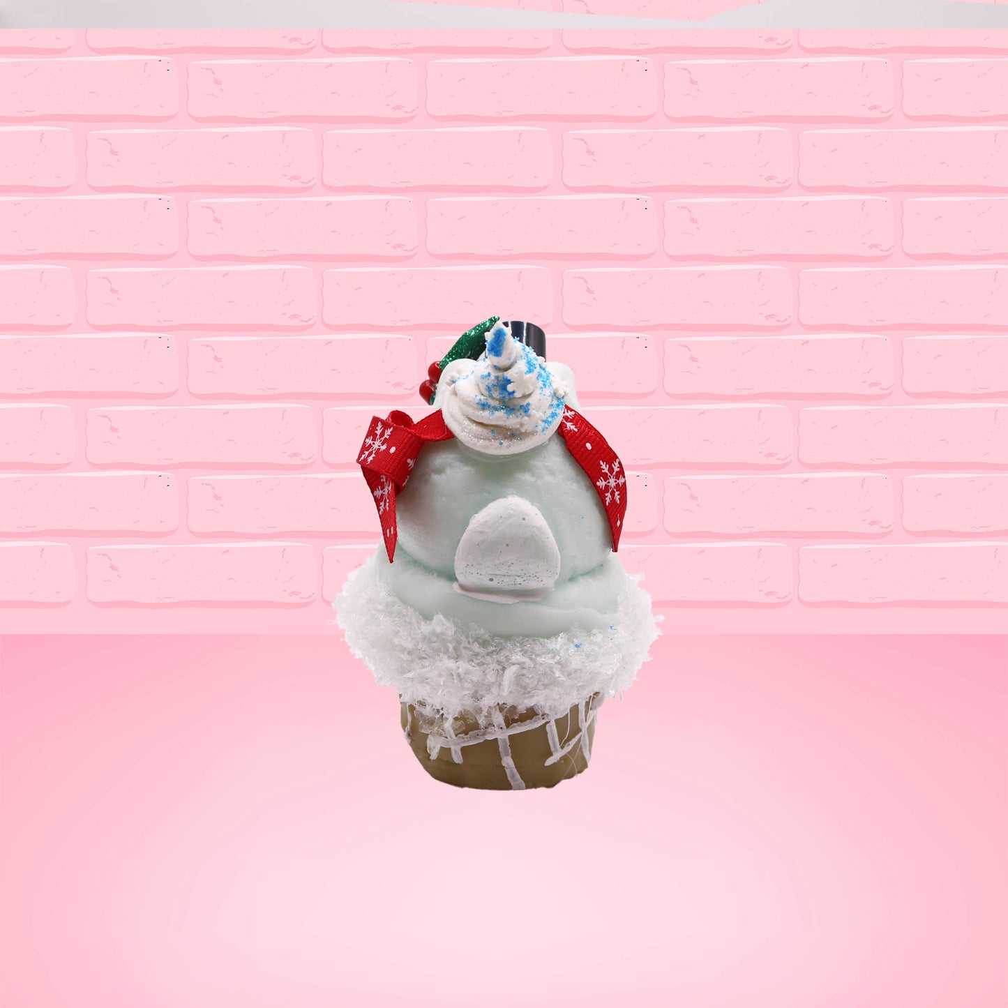 Cute kawaii bunny Snow Bunny light blue ice cream scoop with a carrot nose, red with silver snowflakes ribbon, a black top hat, and holly leaves with berries near the blue glittered whipped cream swirl on the top of the bunny. This view is from the back.