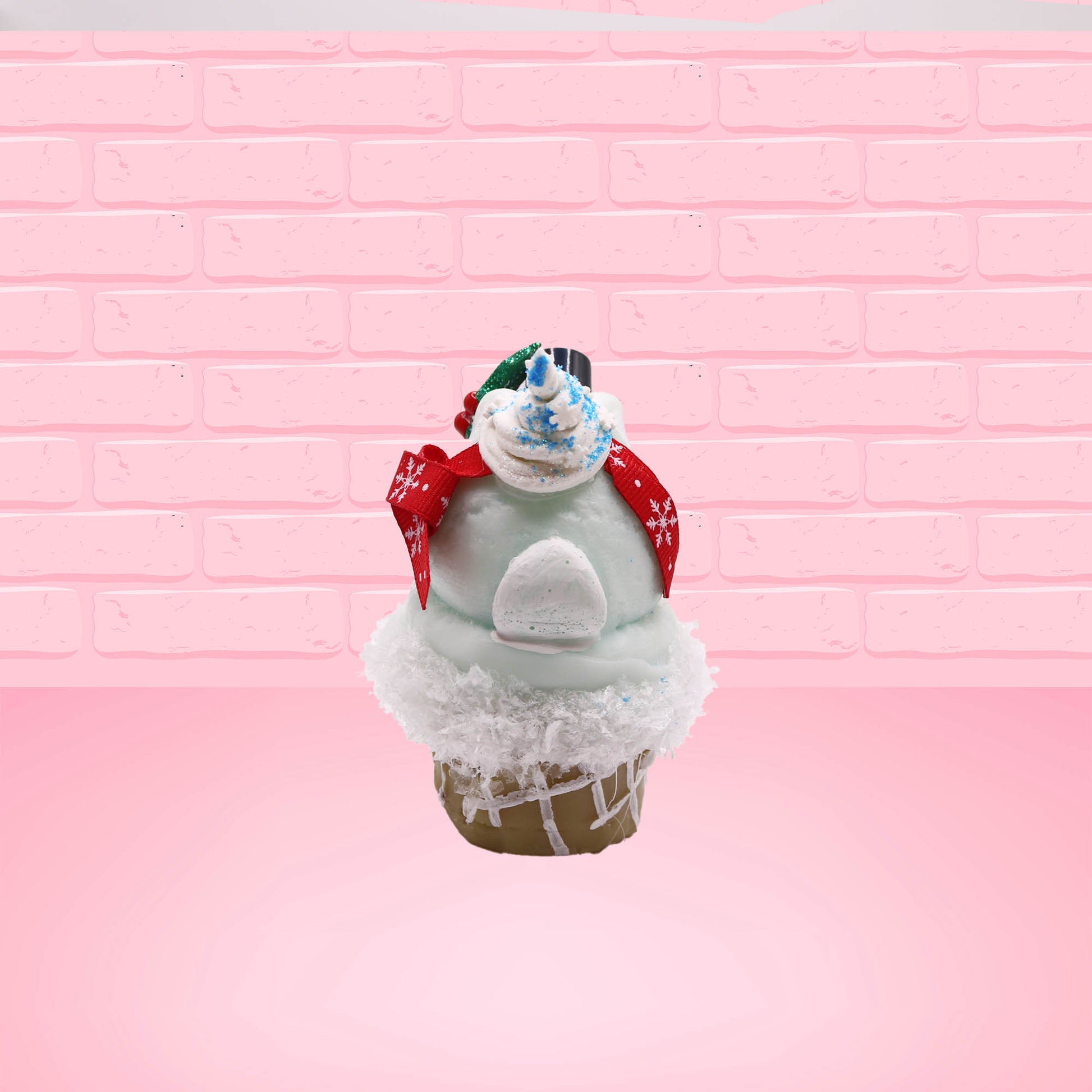 Cute kawaii bunny Snow Bunny light blue ice cream scoop with a carrot nose, red with silver snowflakes ribbon, a black top hat, and holly leaves with berries near the blue glittered whipped cream swirl on the top of the bunny. This view is from the back.