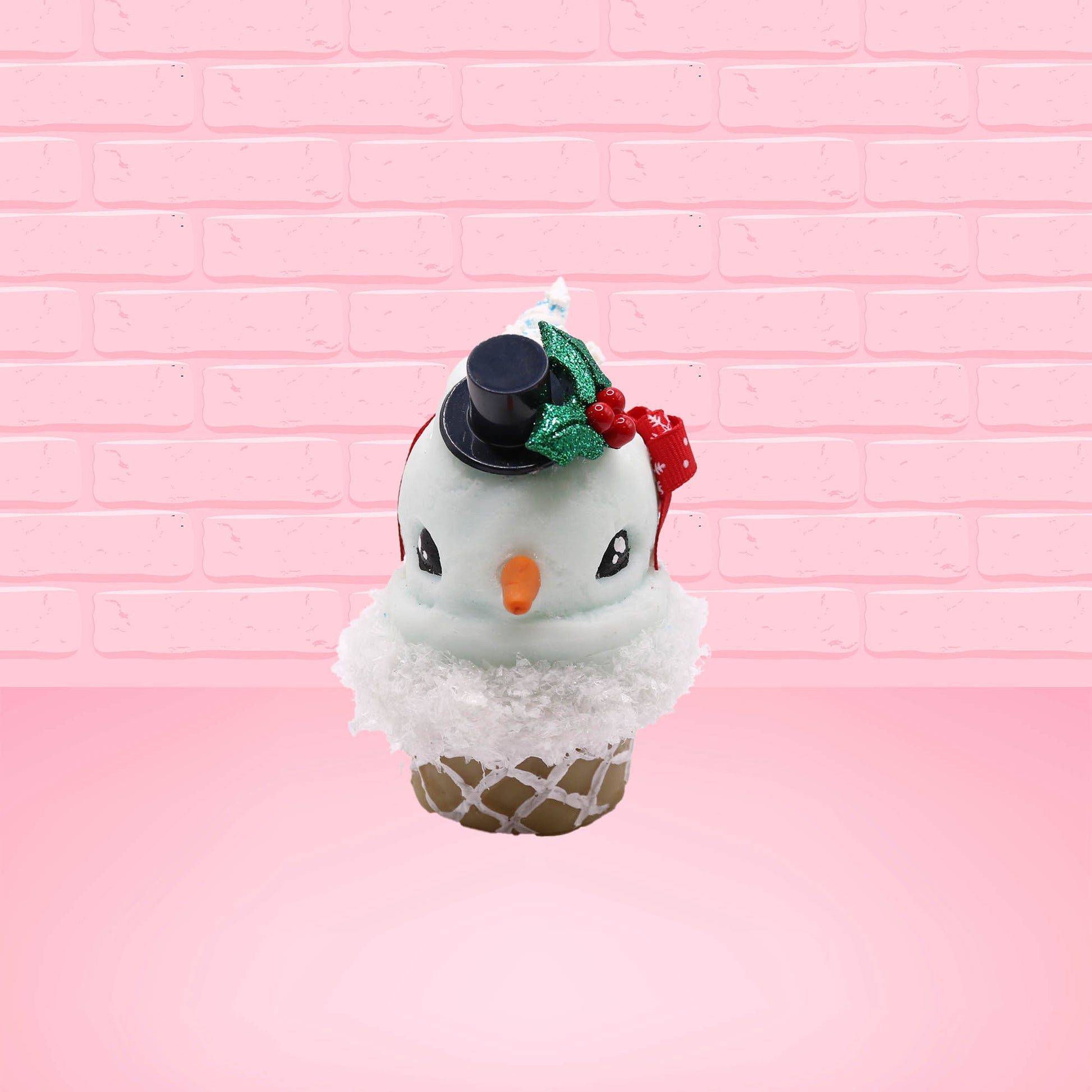 Cute kawaii bunny Snow Bunny light blue ice cream scoop with a carrot nose, red with silver snowflakes ribbon, a black top hat, and holly leaves with berries near the blue glittered whipped cream swirl on the top of the bunny. This view is from the front.