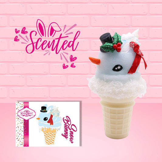 Cute kawaii bunny Snow Bunny light blue ice cream scoop with a carrot nose, red with silver snowflakes ribbon, a black top hat, and holly leaves with berries near the blue glittered whipped cream swirl on the top of the bunny. The front of the character card is shown, as well as the word scented.