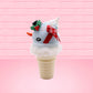 Cute kawaii bunny Snow Bunny light blue ice cream scoop with a carrot nose, red with silver snowflakes ribbon, a black top hat, and holly leaves with berries near the blue glittered whipped cream swirl on the top of the bunny. This view is from the side.