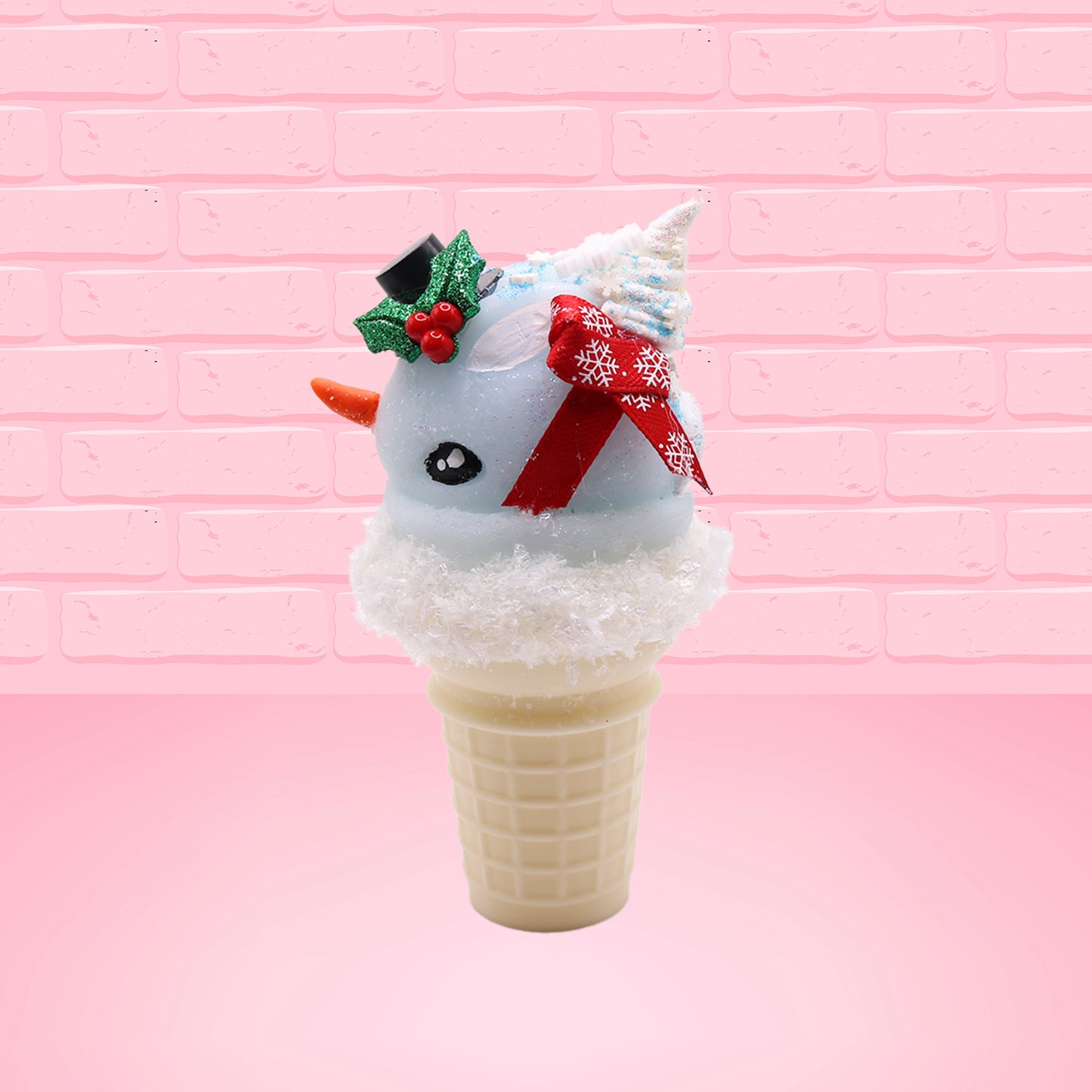 Cute kawaii bunny Snow Bunny light blue ice cream scoop with a carrot nose, red with silver snowflakes ribbon, a black top hat, and holly leaves with berries near the blue glittered whipped cream swirl on the top of the bunny. This view is from the side.