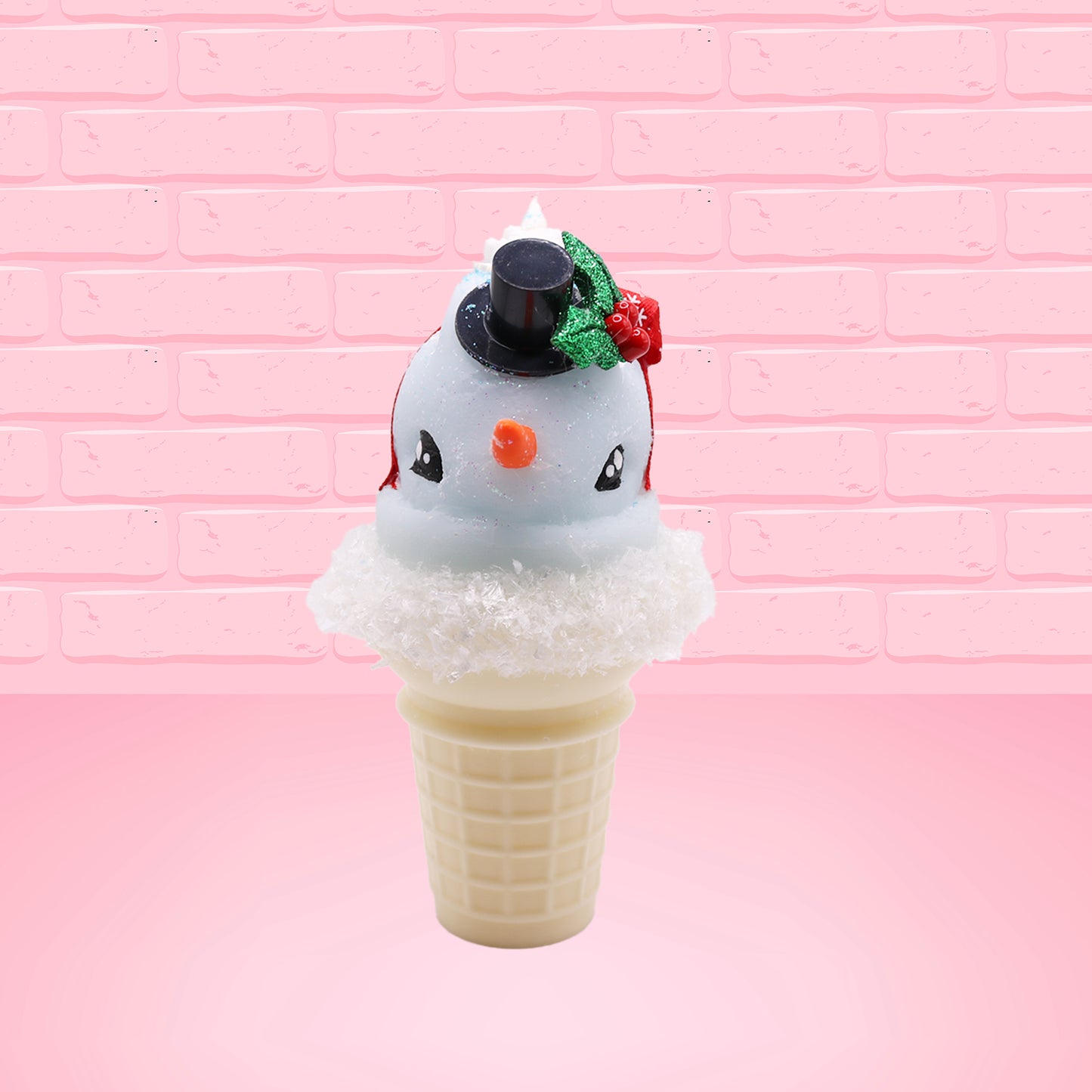 Cute kawaii bunny Snow Bunny light blue ice cream scoop with a carrot nose, red with silver snowflakes ribbon, a black top hat, and holly leaves with berries near the blue glittered whipped cream swirl on the top of the bunny. This view is from the front.
