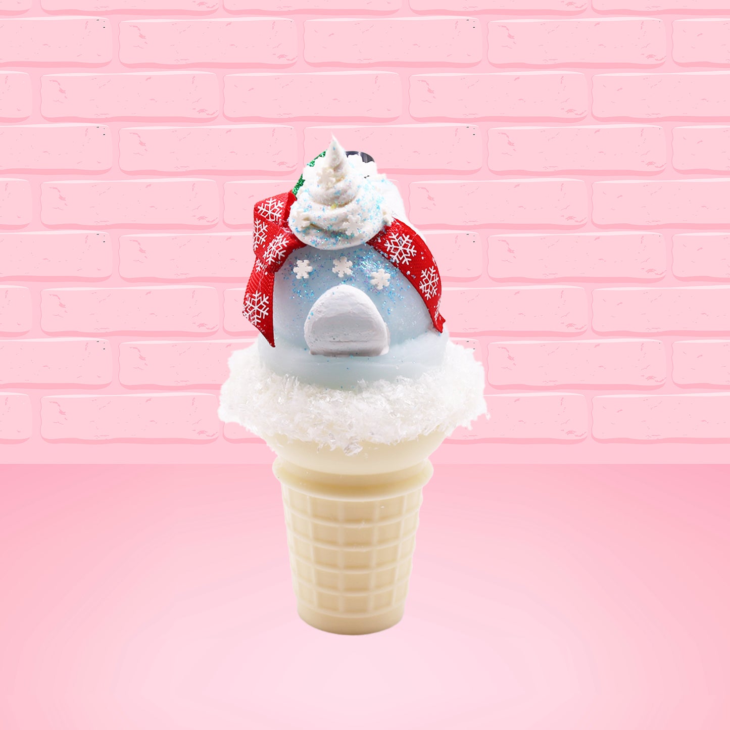 Cute kawaii bunny Snow Bunny light blue ice cream scoop with a carrot nose, red with silver snowflakes ribbon, a black top hat, and holly leaves with berries near the blue glittered whipped cream swirl on the top of the bunny. This view is from the back.
