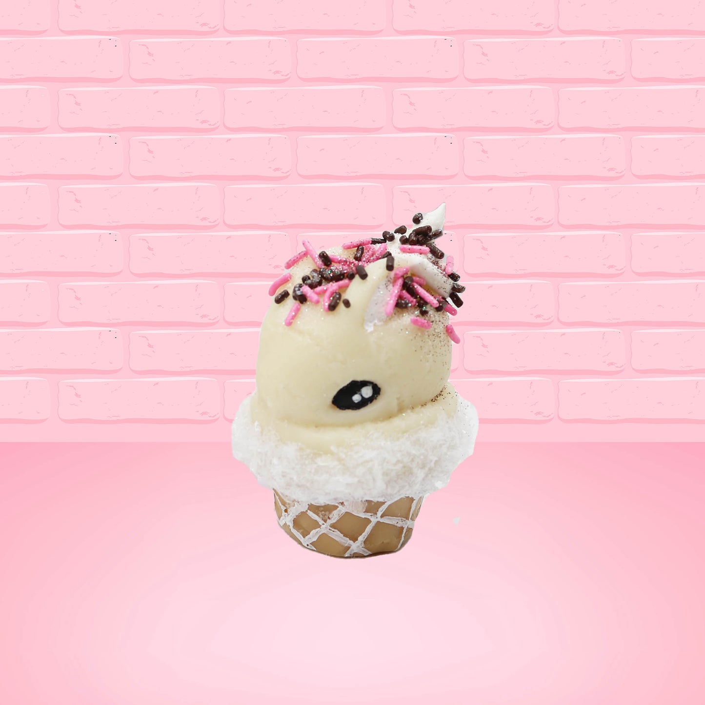Cute kawaii bunny white ice cream cone Vanilla Pink Sprinkle with black and pink sprinkles on top with a swirl of whipped cream. This view is from the side at an angle.