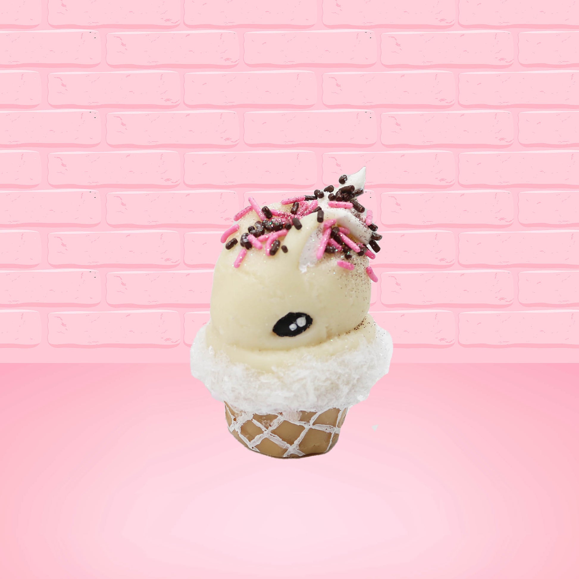 Cute kawaii bunny white ice cream cone Vanilla Pink Sprinkle with black and pink sprinkles on top with a swirl of whipped cream. This view is from the side at an angle.