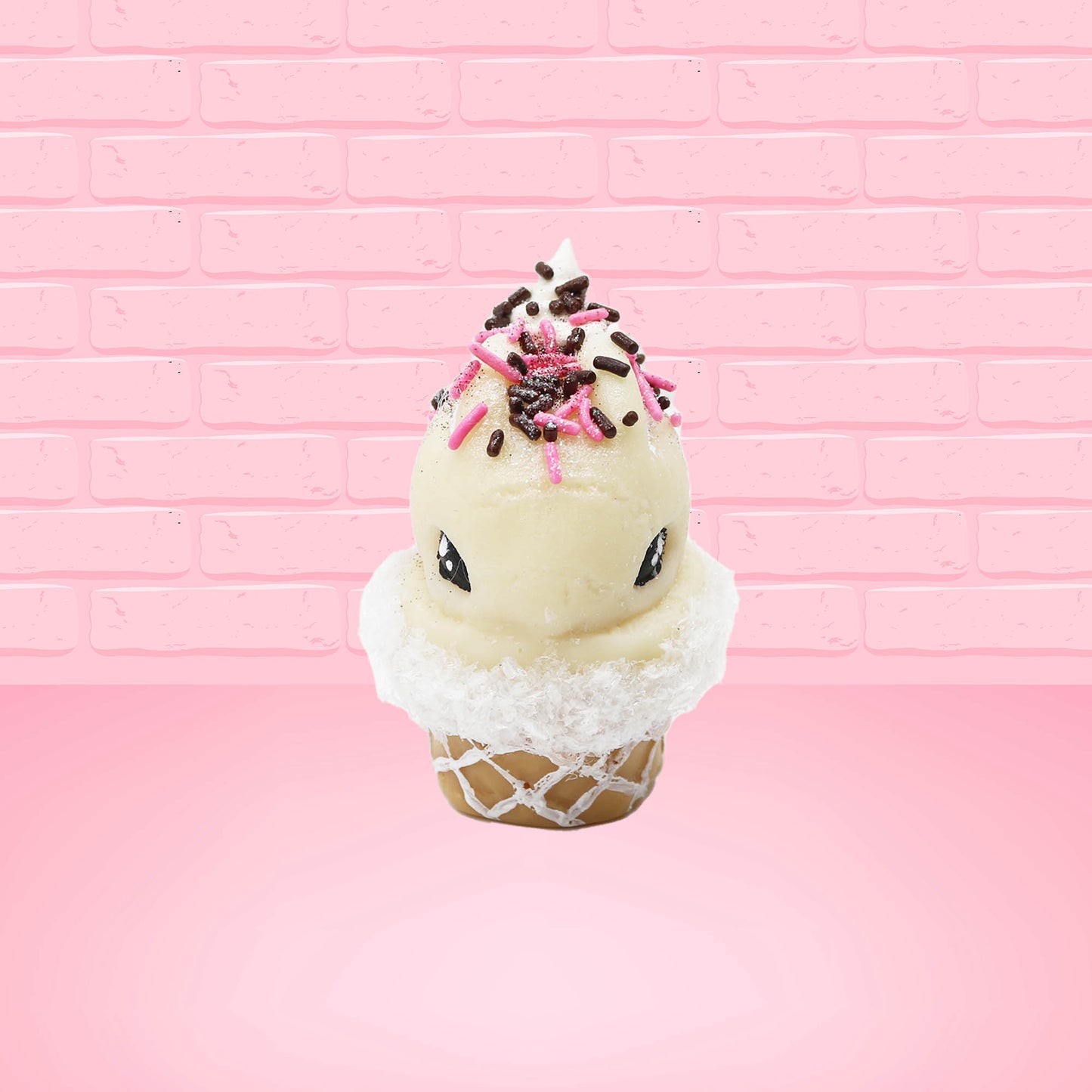 Cute kawaii bunny white ice cream cone Vanilla Pink Sprinkle with black and pink sprinkles on top with a swirl of whipped cream. This view is from the front.