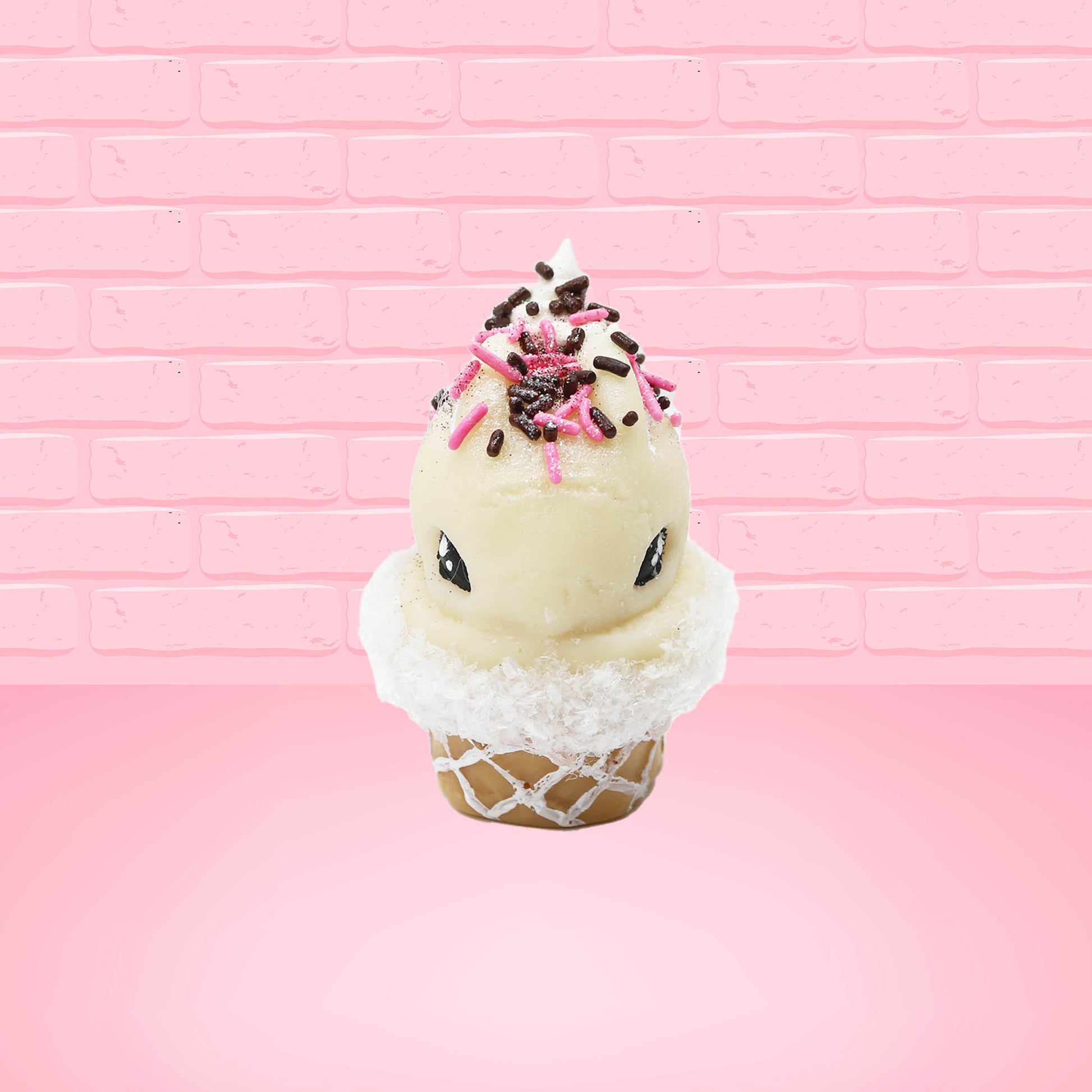 Cute kawaii bunny white ice cream cone Vanilla Pink Sprinkle with black and pink sprinkles on top with a swirl of whipped cream. This view is from the front.