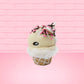 Cute kawaii bunny white ice cream cone Vanilla pink Sprinkle with black and pink sprinkles on top with a swirl of whipped cream. This view is from the side.