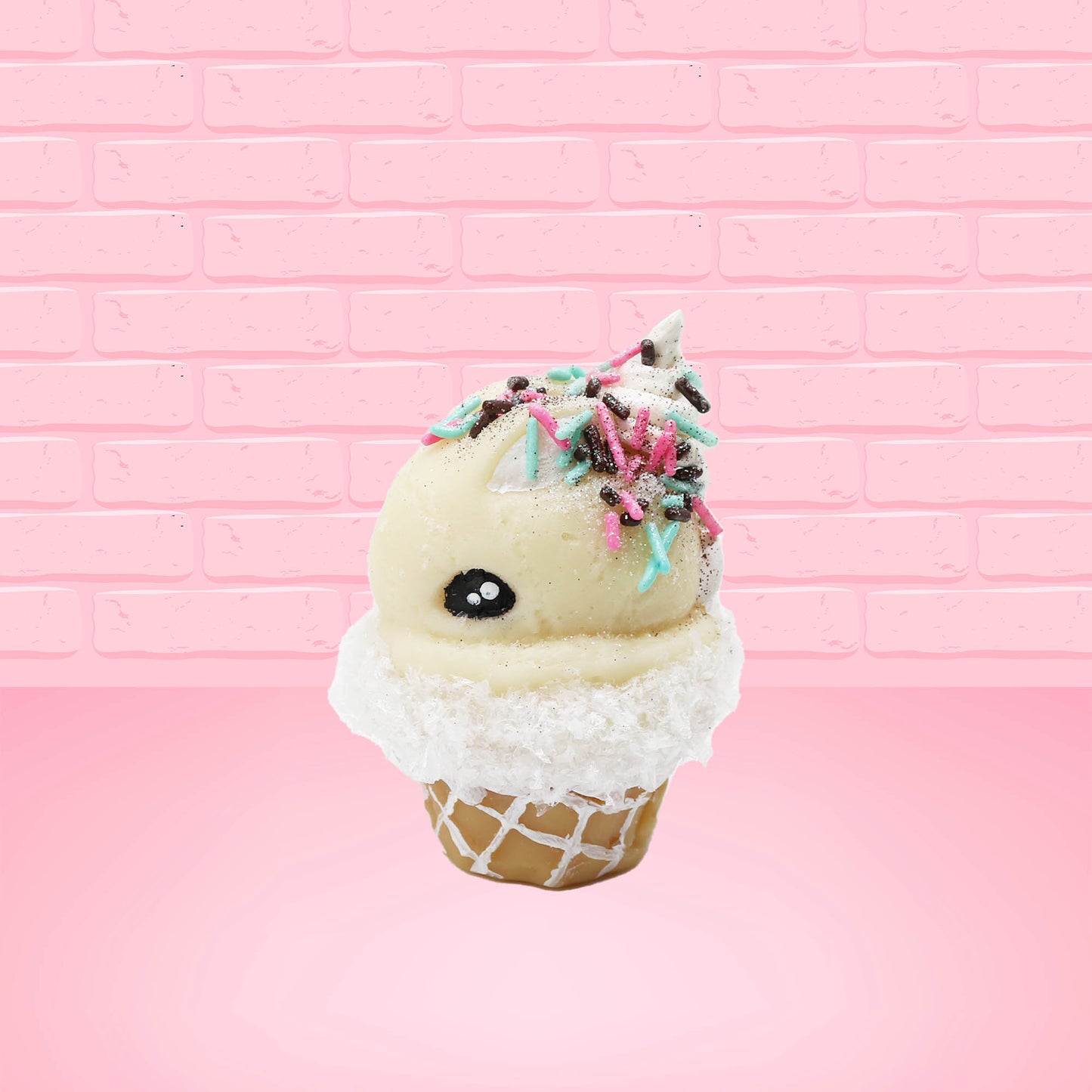 Cute kawaii bunny white ice cream cone with pink, teal, and black sprinkles on top of the bunny near the whipped cream swirl. The view is from the side. 