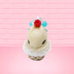 Cute kawaii bunny Vanilla Star Blast white ice cream cone with a blueberry, raspberry, and silver pearls near the swirl of whipped cream on the top of the bunny. This view is from the front.