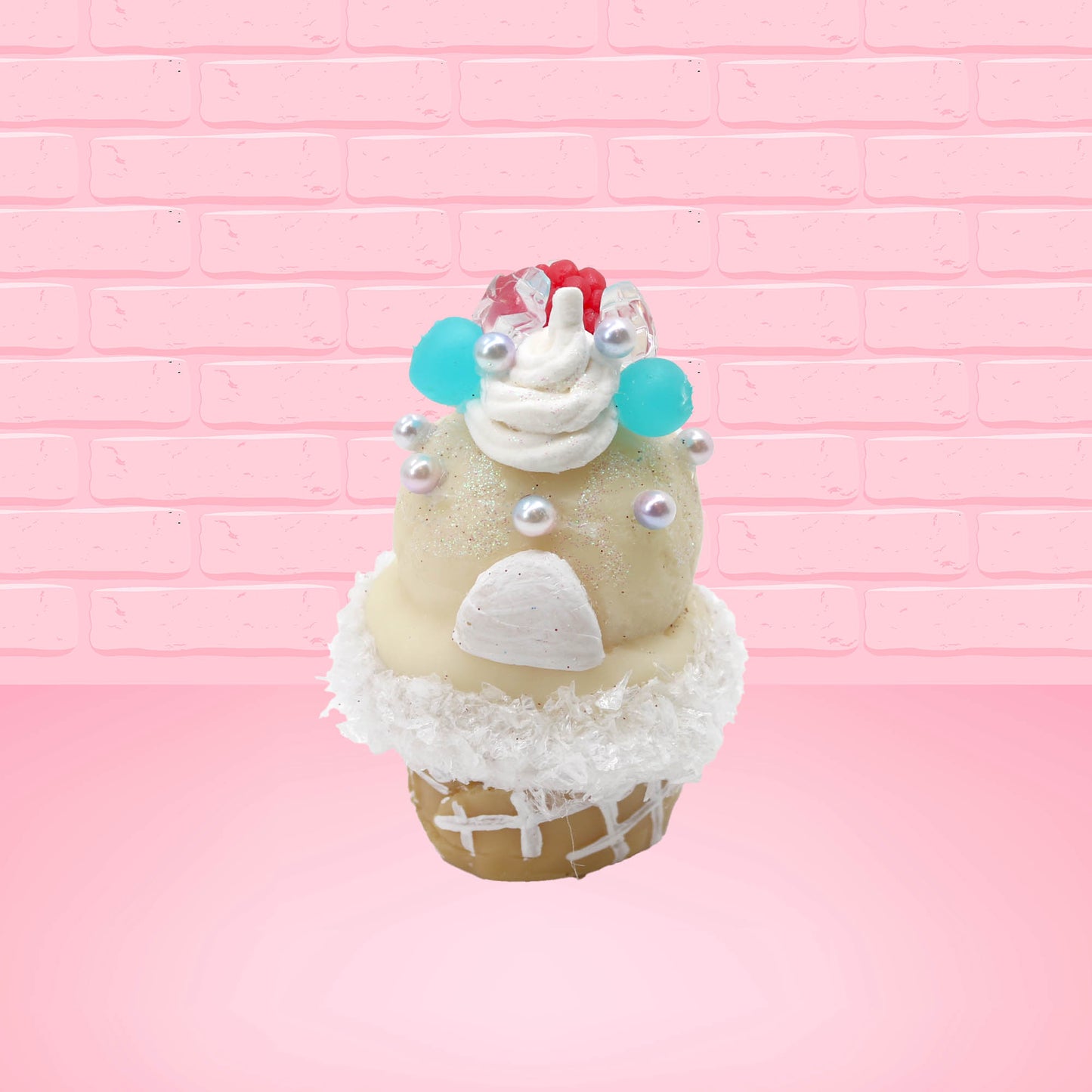 Cute kawaii bunny Vanilla Star Blast white ice cream cone with a blueberry, raspberry, and silver pearls near the swirl of whipped cream on the top of the bunny. This view is from the back.