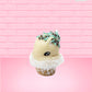 Cute kawaii bunny white ice cream cone Vanilla Teal Sprinkle with black and teal sprinkles on top with a swirl of whipped cream. This view is from the side at an angle.
