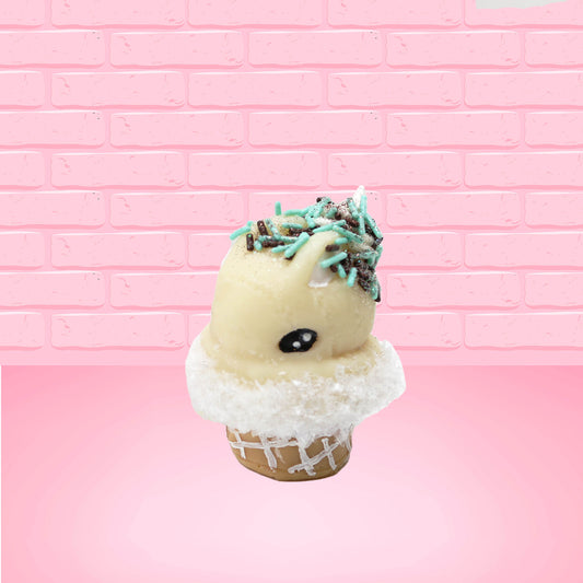Cute kawaii bunny white ice cream cone Vanilla Teal Sprinkle with black and teal sprinkles on top with a swirl of whipped cream. This view is from the side at an angle.