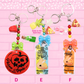 Keychains D, E, F are shown, which are Poison Apple tag, Pineapple Bunny Poppers and Glow in the Dark Star are shown, and Pepperoni Bunny Poppers Glow in the Dark Star are shown.