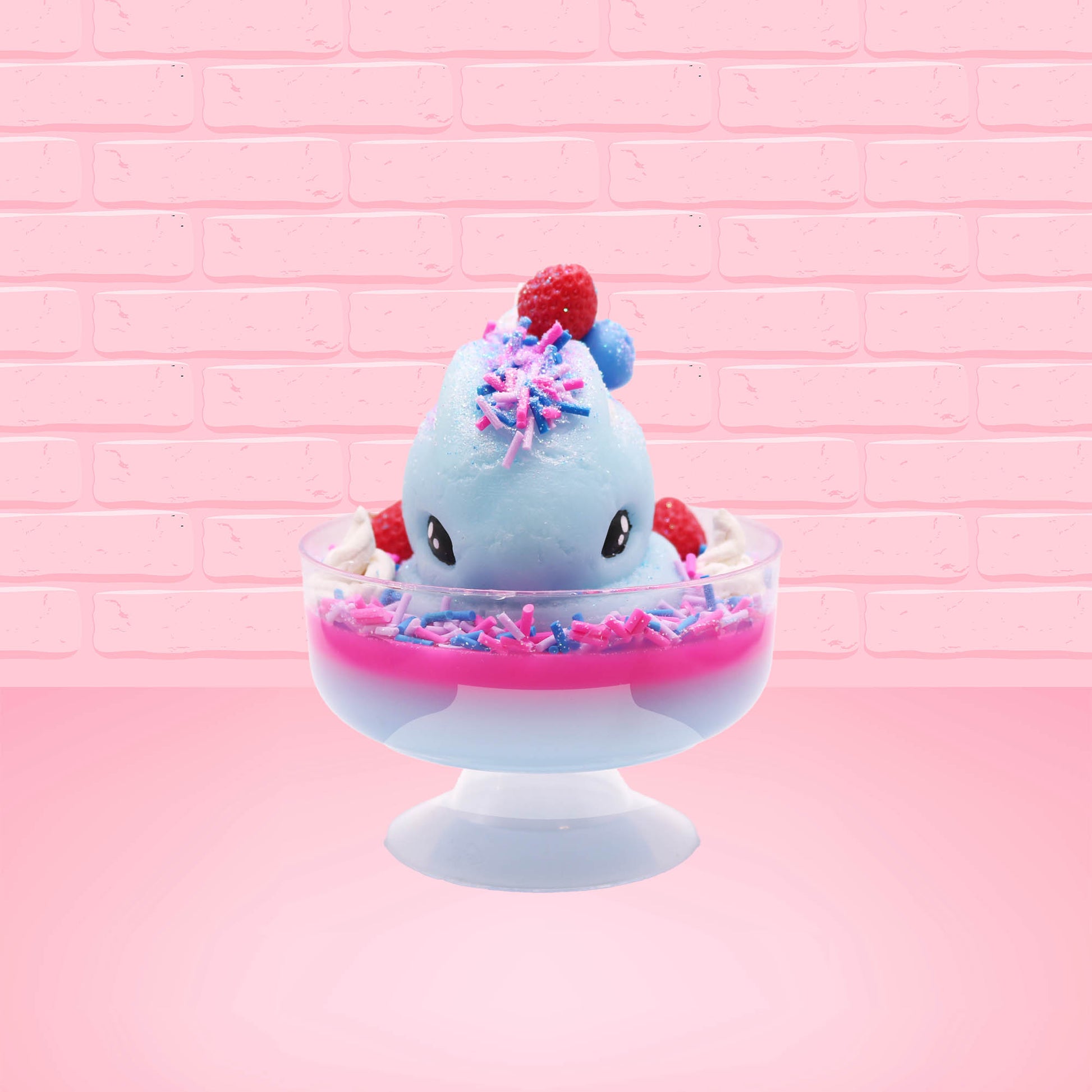 Cute kawaii Berry Swirl Cotton Candy blue ice cream sundae with pink glaze, pink blue and white sprinkles, strawberries and whipped cream swirls in the dish.  There are sprinkles, a blue berry, and strawberry on the top of the bunny near the swirl of the whipped cream. This view is from the front.