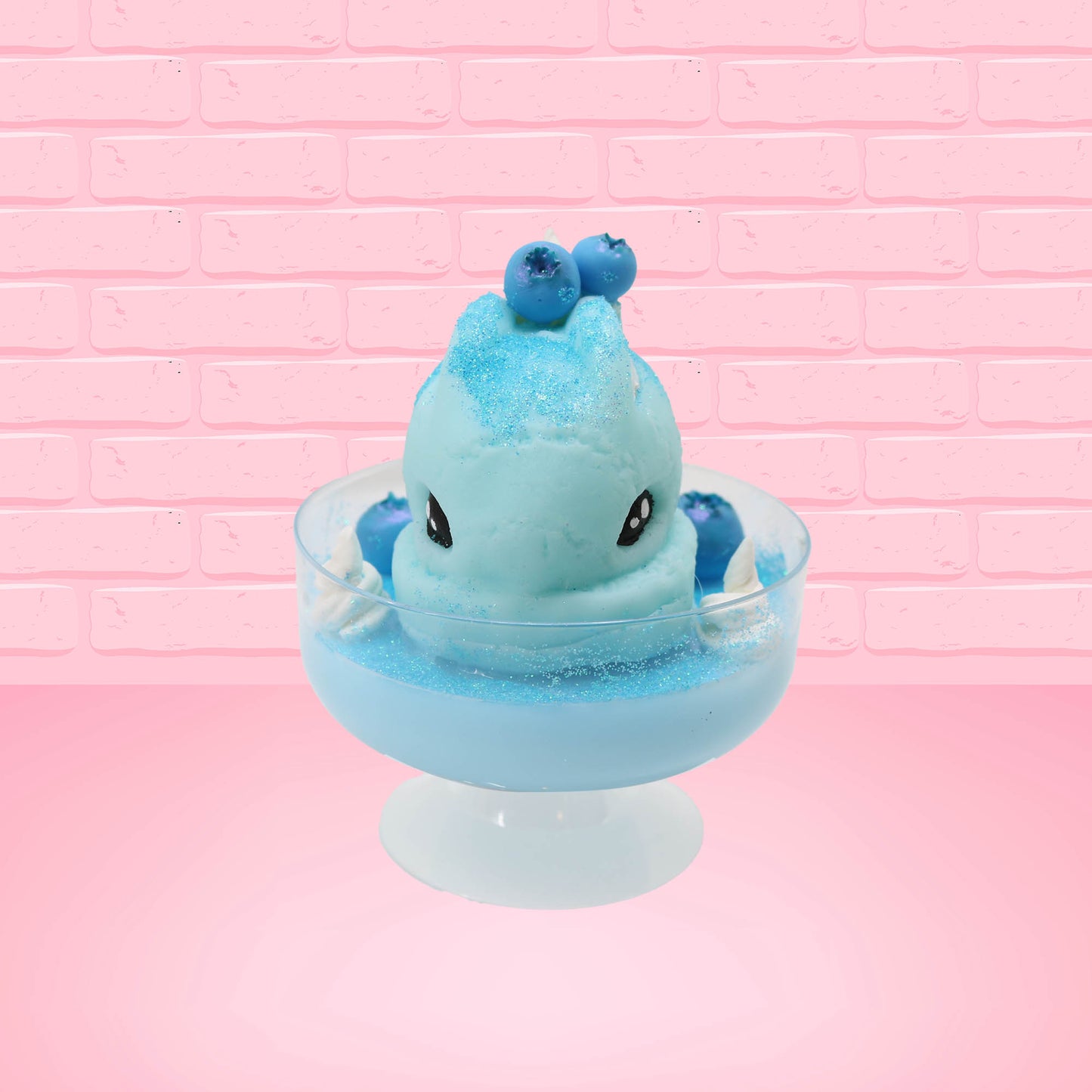 Cute kawaii Blue Berry Cotton Candy ice cream sundae with blue berries and swirls of whipped cream in the dish, while covered with blue glitter.  The bunny has two blue berries on the top near the swirl of whipped cream on the back. This view is from the front.