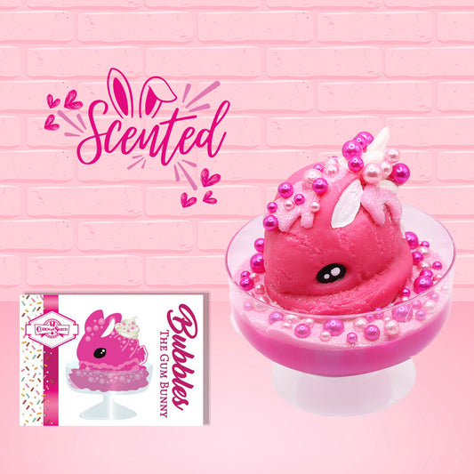 Cute kawaii bunny Bubbles pink ice cream sundae with light pink drizzle, pink and hot pink metallic spheres inside the dish. The bunny’s top is covered with the pink and hot pink spheres as well as a swirl of whipped cream. The front of the character card is shown as well as the word scented.