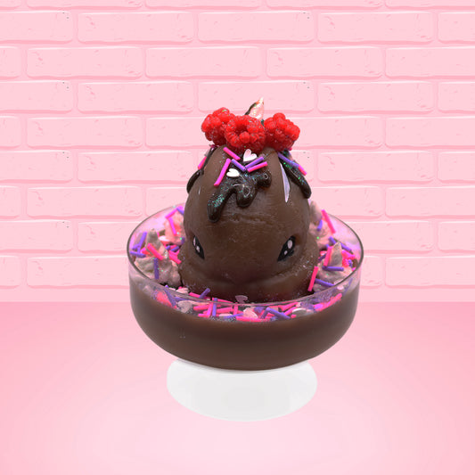 Cute kawaii bunny Chocolate Rush brown ice cream sundae with pink and purple sprinkles with swirls of whipped cream in the dish. The bunny has raspberries, chocolate glittery drizzle and sprinkles on top near the whipped cream swirl. This view is from the front.