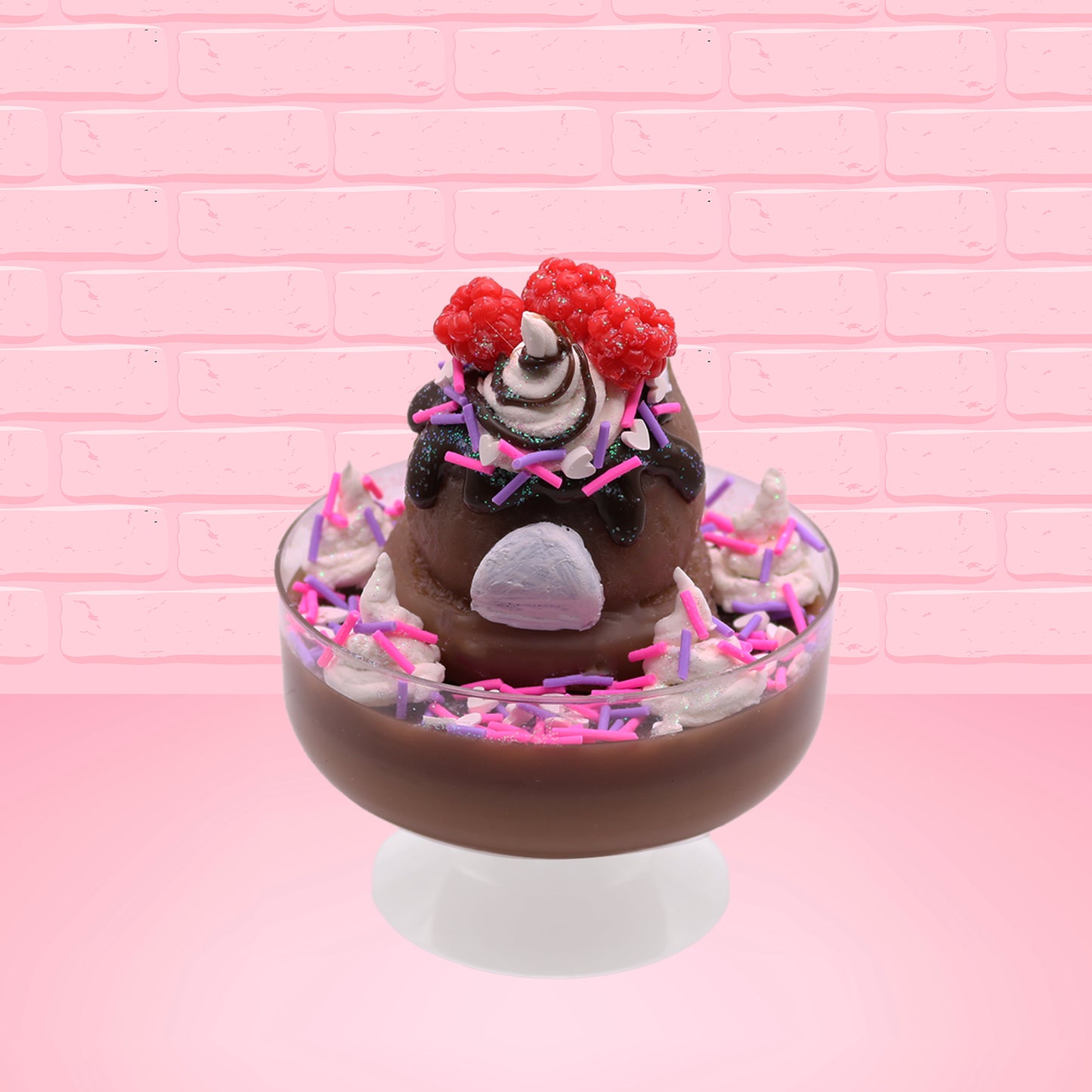 Cute kawaii bunny Chocolate Rush brown ice cream sundae with pink and purple sprinkles with swirls of whipped cream in the dish. The bunny has raspberries, chocolate glittery drizzle and sprinkles on top near the whipped cream swirl. This is from the back.