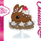 The front of the character card for Chocolate Rush shows the digital artwork. The artwork shows the brown ice cream sundae with pink and purple sprinkles with swirls of whipped cream in the dish. The bunny has raspberries, chocolate glittery drizzle and sprinkles on top near the whipped cream swirl.