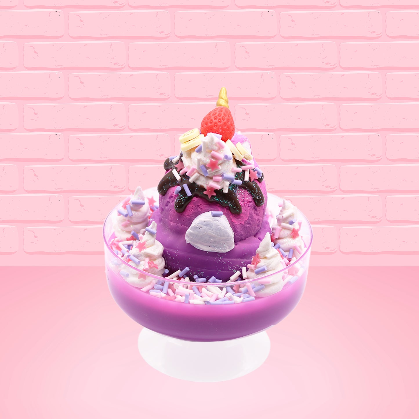 Cute kawaii unicorn bunny Coco Dazzle Star purple ice cream with pink, purple and white sprinkles with swirls of whipped cream in the dish. The unicorn bunny has a strawberry and banana slices with chocolate drizzle and sprinkles near the whipped cream swirl. This view is from the back.