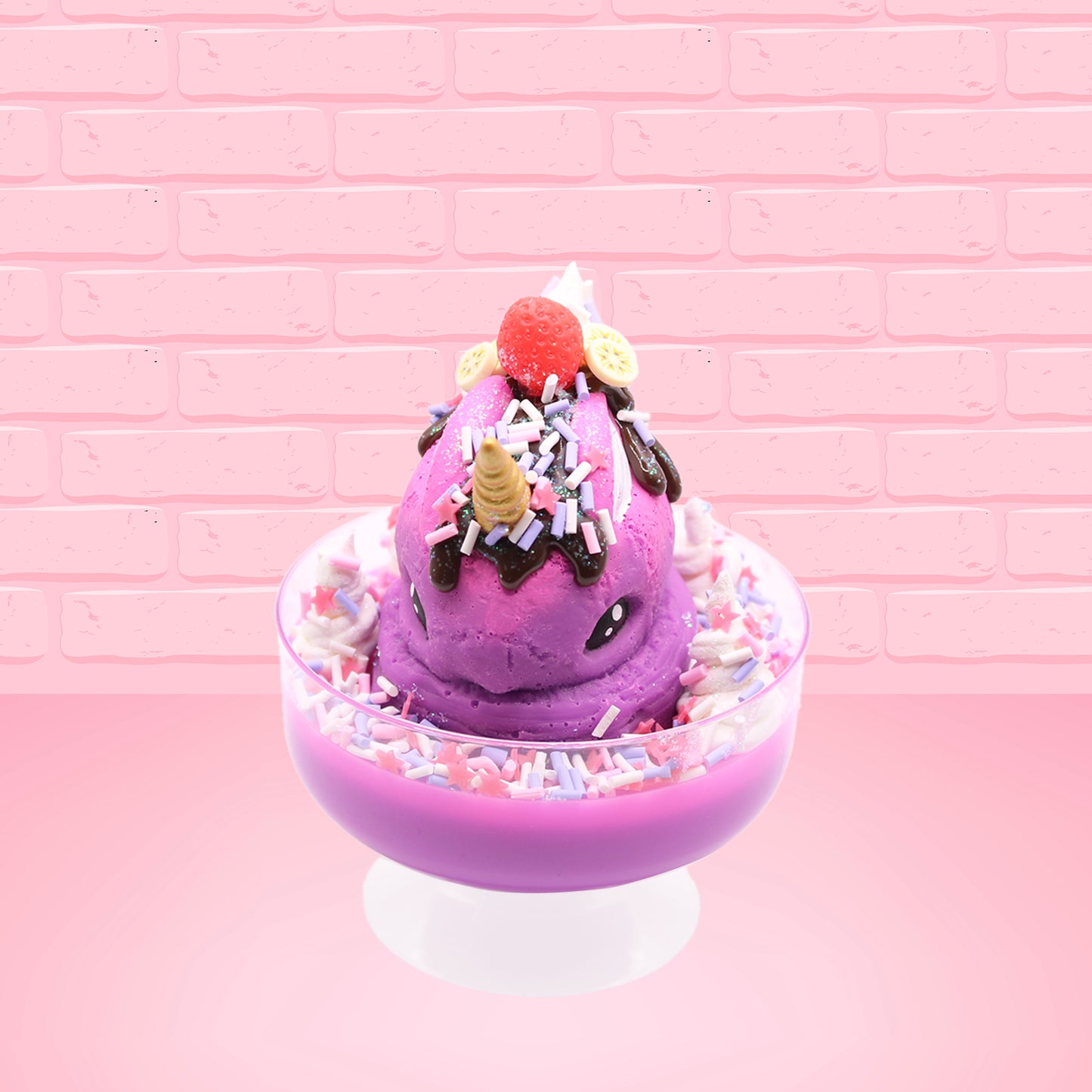 Cute kawaii unicorn bunny Coco Dazzle Star purple ice cream with pink, purple and white sprinkles with swirls of whipped cream in the dish. The unicorn bunny has a strawberry and banana slices with chocolate drizzle and sprinkles near the whipped cream swirl. This view is from the front.
