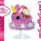 The front of the character card for Unicorn Bunny Coco Dazzle Star which shows the digital artwork. The artwork shows the purple ice cream sundae with pink, purple and white sprinkles with swirls of whipped cream in the dish. The unicorn bunny has a strawberry and banana slices with chocolate drizzle and sprinkles near the whipped cream swirl.