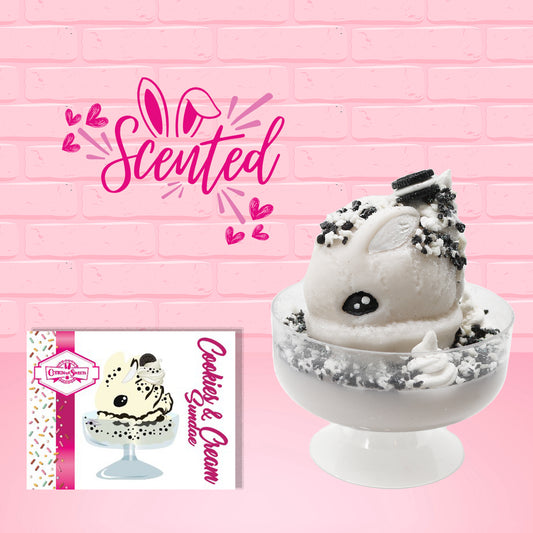 Cute kawaii bunny cookies and cream ice cream white scoop sundae with whipped cream swirls and black white crumbles in the dish. A black and white sandwhich cookie is on top of the resin bunny, sprinkled with black and white crumbles and a swirl of whipped cream. The front of the character card is shown with the word scented.