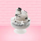 Cute kawaii bunny cookies and cream ice cream white scoop sundae with whipped cream swirls and black white crumbles in the dish. A black and white sandwhich cookie is on top of the resin bunny, sprinkled with black and white crumbles and a swirl of whipped cream. This view is from the other side.