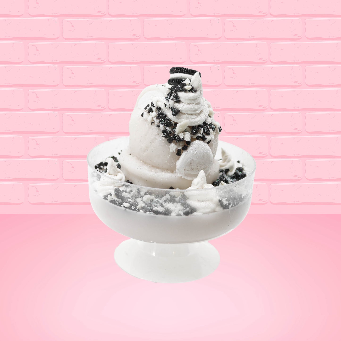 Cute kawaii bunny cookies and cream ice cream white scoop sundae with whipped cream swirls and black white crumbles in the dish. A black and white sandwhich cookie is on top of the resin bunny, sprinkled with black and white crumbles and a swirl of whipped cream. This view is from the back.