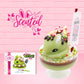 Cute kawaii ice cream Emotional Grinch Fudge sundae which has a sign and green white and red heart sprinkles inside of the dish as well as swirls of whipped cream. The bunny has chocolate glaze, peppermint candies and a swirl of whipped cream on it’s head. The character card front is shown as well as the word scented. 