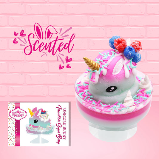 Cute kawaii unicorn bunny Irresistible Sugary Berry light blue and pink sundae with light blue and pink sprinkles with whipped cream swirls in the dish.  The unicorn bunny has blue berries and red raspberries on top near the whipped cream swirl with white drizzle coming down.  The front of the character card is shown, and the word scented.