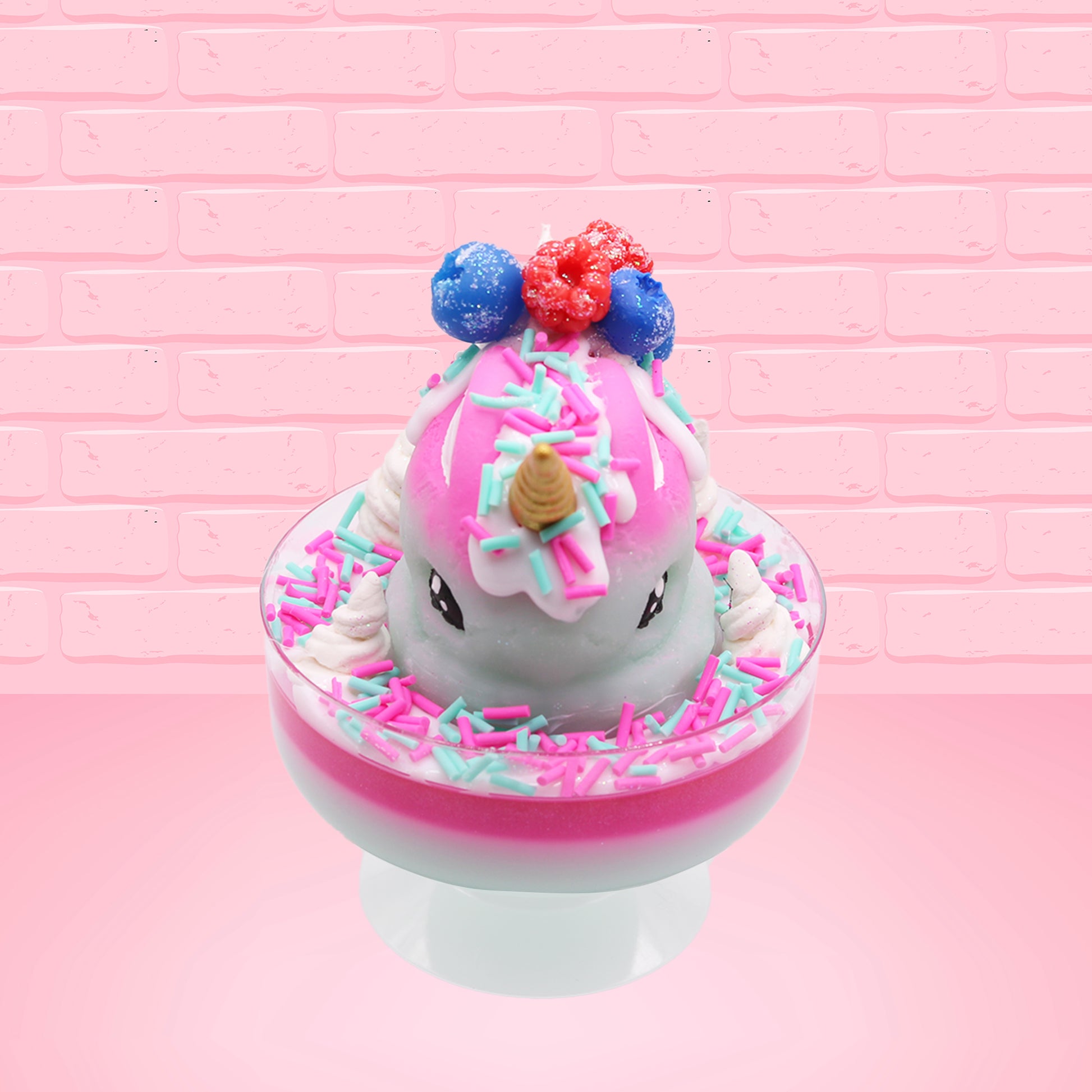 Cute kawaii unicorn bunny Irresistible Sugary Berry light blue and pink sundae with light blue and pink sprinkles with whipped cream swirls in the dish.  The unicorn bunny has blue berries and red raspberries on top near the whipped cream swirl with white drizzle coming down. This view is from the front.