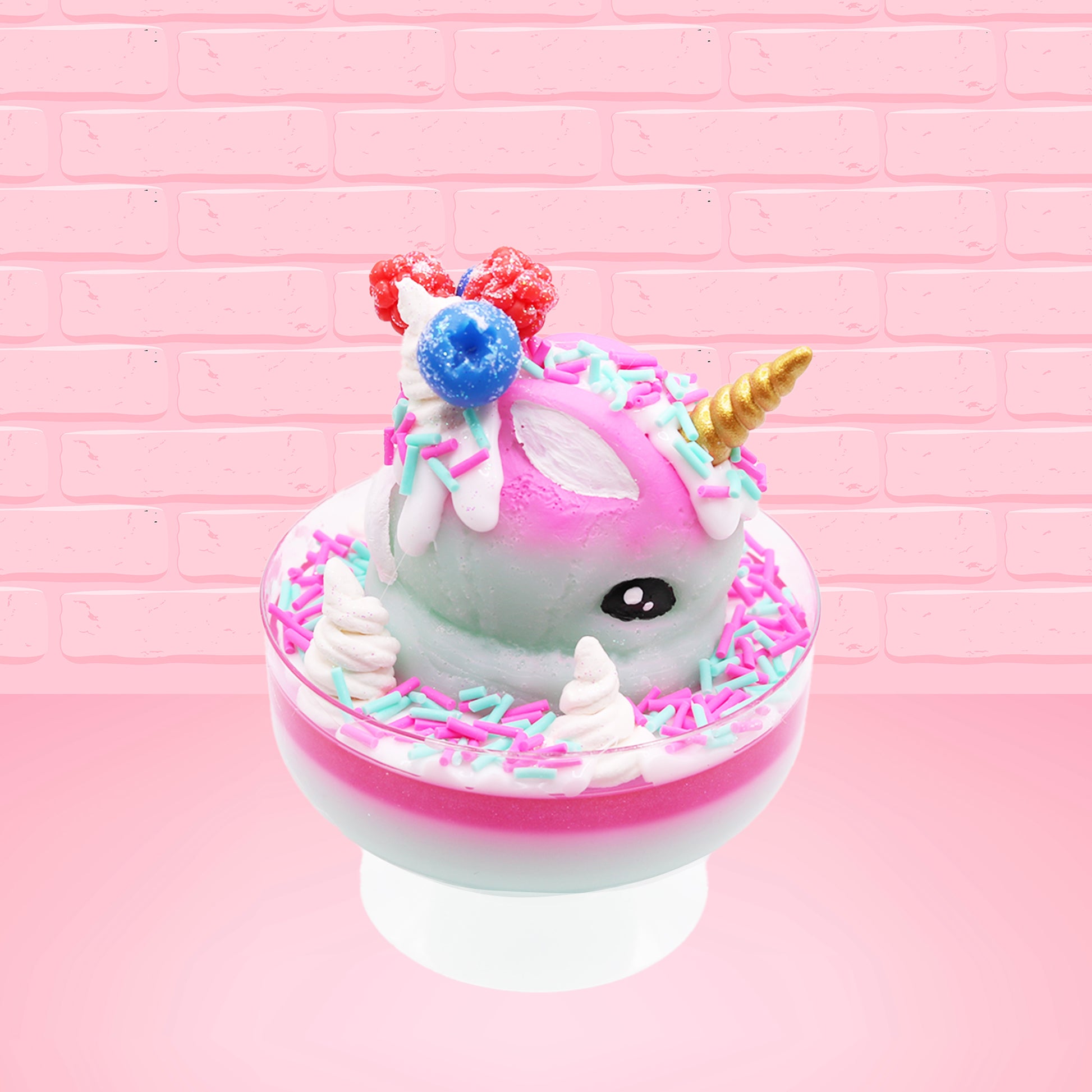 Cute kawaii unicorn bunny Irresistible Sugary Berry light blue and pink sundae with light blue and pink sprinkles with whipped cream swirls in the dish.  The unicorn bunny has blue berries and red raspberries on top near the whipped cream swirl with white drizzle coming down. This view is from the side.