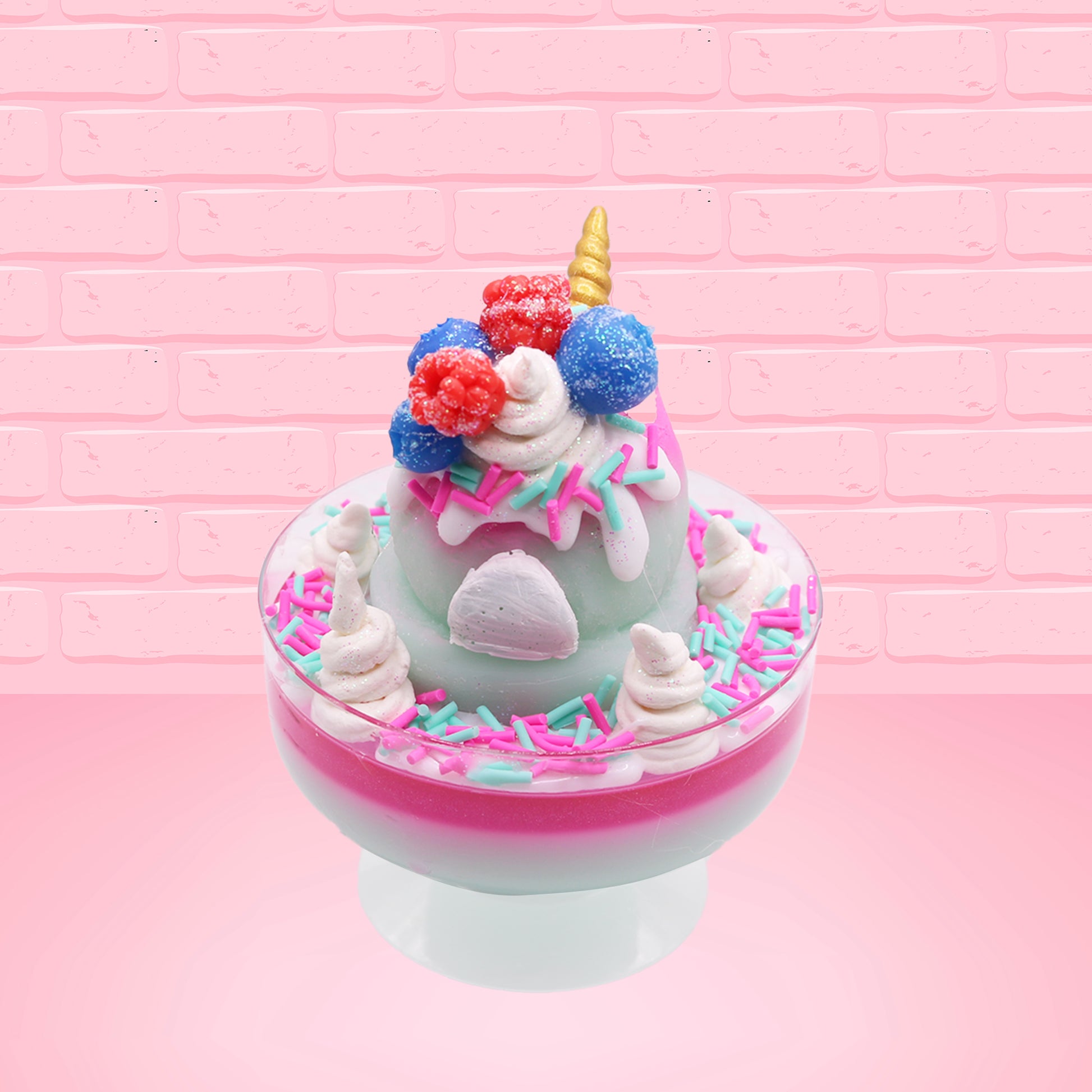 Cute kawaii unicorn bunny Irresistible Sugary Berry light blue and pink sundae with light blue and pink sprinkles with whipped cream swirls in the dish.  The unicorn bunny has blue berries and red raspberries on top near the whipped cream swirl with white drizzle coming down. This view is from the back.