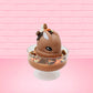 Cute kawaii peanut chocolate cup resin ice cream sundae with orange and white sprinkles in the dish. Chocolate drizzle and cups are on the top of the resin ice cream bunny, and a swirl whipped cream on top at a slight angle from the front.
