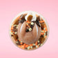 Cute kawaii bunny peanut chocolate cup resin ice cream sundae with orange and white sprinkles in the dish. Chocolate drizzle and cups are on the top of the resin ice cream bunny, and a swirl whipped cream on top at a slight angle from the top.