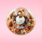 Cute kawaii bunny peanut chocolate cup resin ice cream sundae with orange and white sprinkles in the dish. Chocolate drizzle and cups are on the top of the resin ice cream bunny, and a swirl whipped cream on top at a slight angle from the top focusing on the swirl.