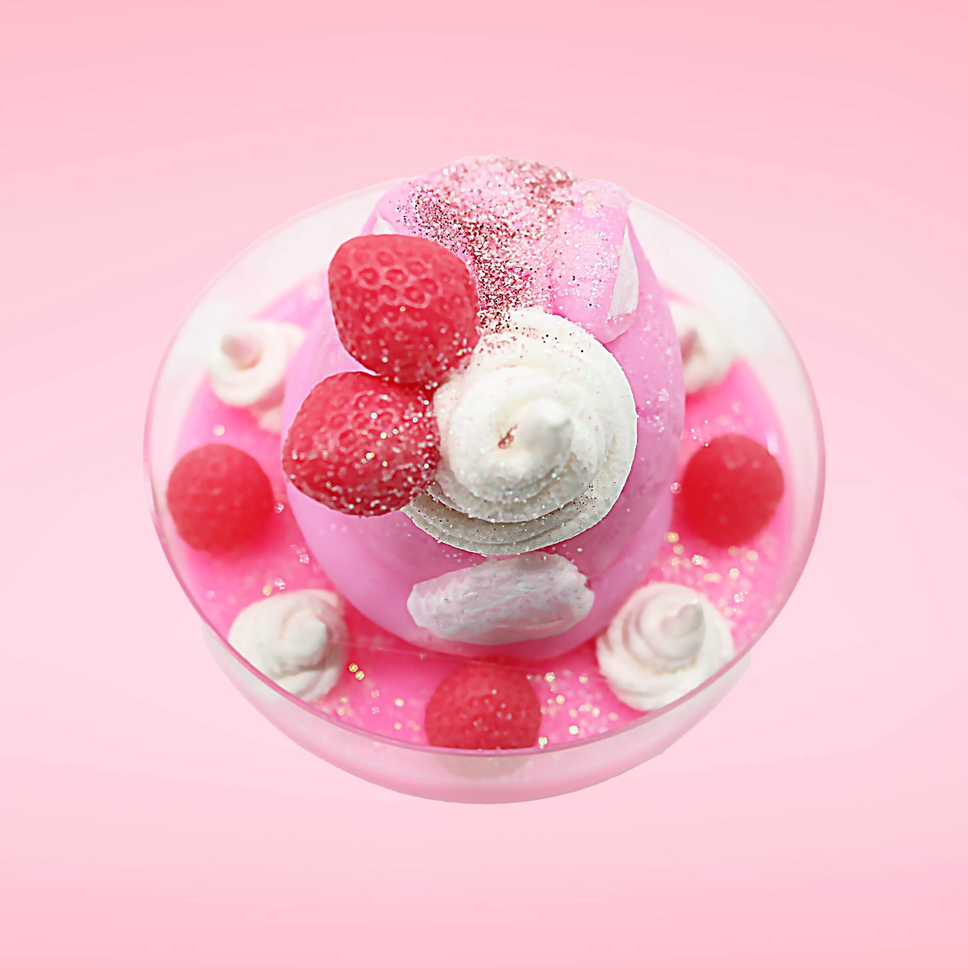 Cute kawaii bunny Pink Swirl Cotton Candy pink ice cream sundae with strawberries and swirls of whipped cream in the dish. The bunny has two strawberries near the swirl of whipped cream on top and white glitter.  This view is from the top.