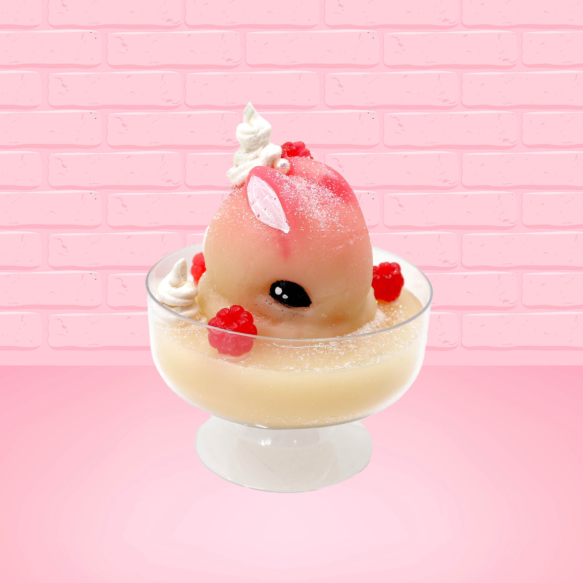Cute kawaii bunny raspberry cheesecake white ice cream with raspberries and whipped cream swirls in the dish. The bunny has two raspberry on the back near the swirl of whipped cream and covered with white glitter. This view is from the front at an angle.