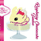 Cute kawaii bunny Raspberry Cheesecake character card front, which has the digital artwork of the character, the name as Raspberry Cheesecake Sundae, with the cotton tail sweets logo. The artwork shows raspberry cheesecake white ice cream with raspberries and whipped cream swirls in the dish.